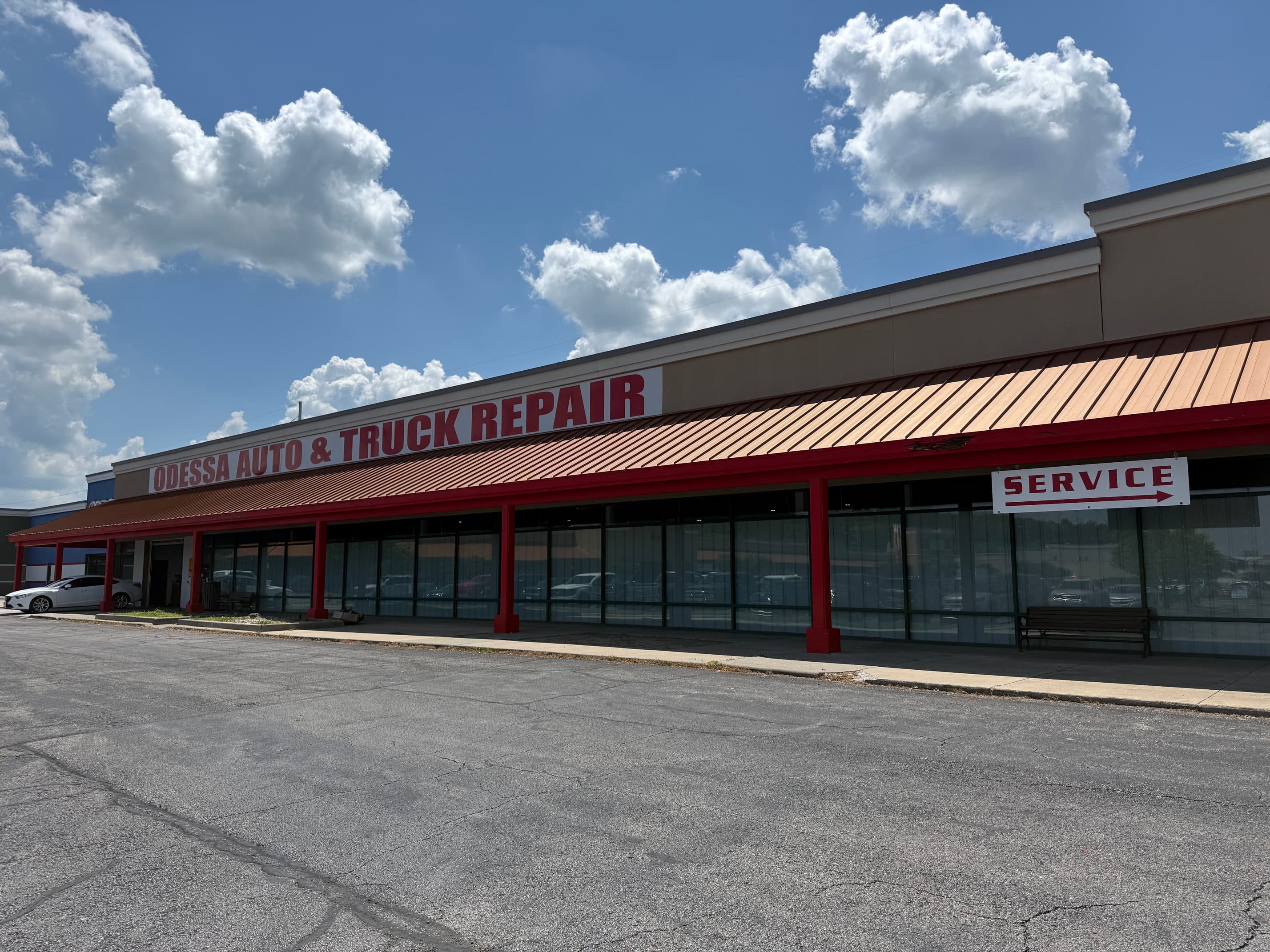 Exterior road sign for Odessa Auto & Truck Repair on US Highway 40 in Odessa, Missouri